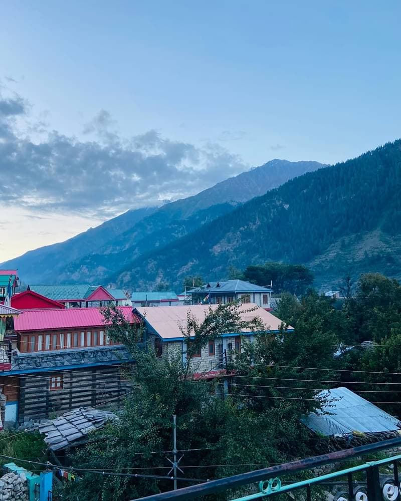Spiti Valley mountain village at dusk with dramatic peaks behind colorful rooftops
